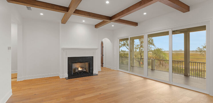 Riverside Homes Custom Home with wood beams in living room